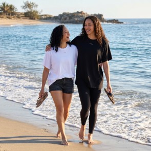 two sisters walking along the beach