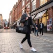 A dancer girl walks through the city